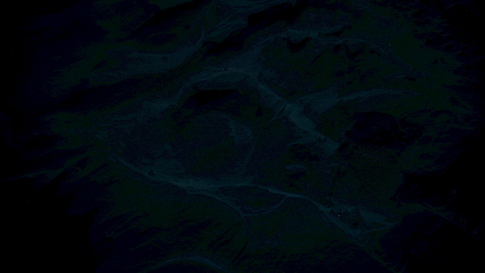 The image is very dark with indistinct shapes, making it hard to identify specific objects or details clearly.